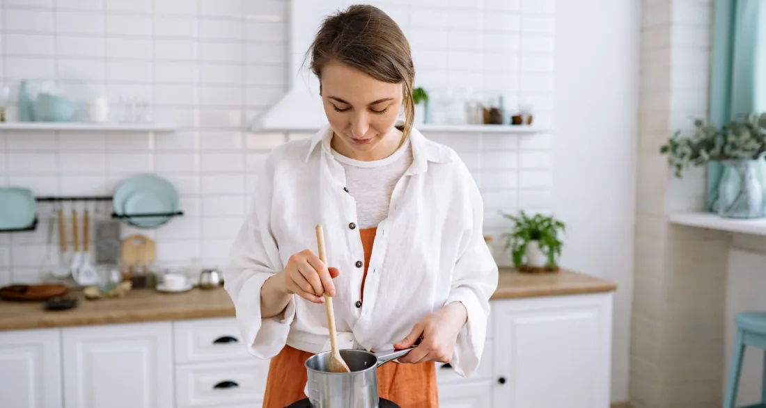 Couple preparing vegetables together at a kitchen island