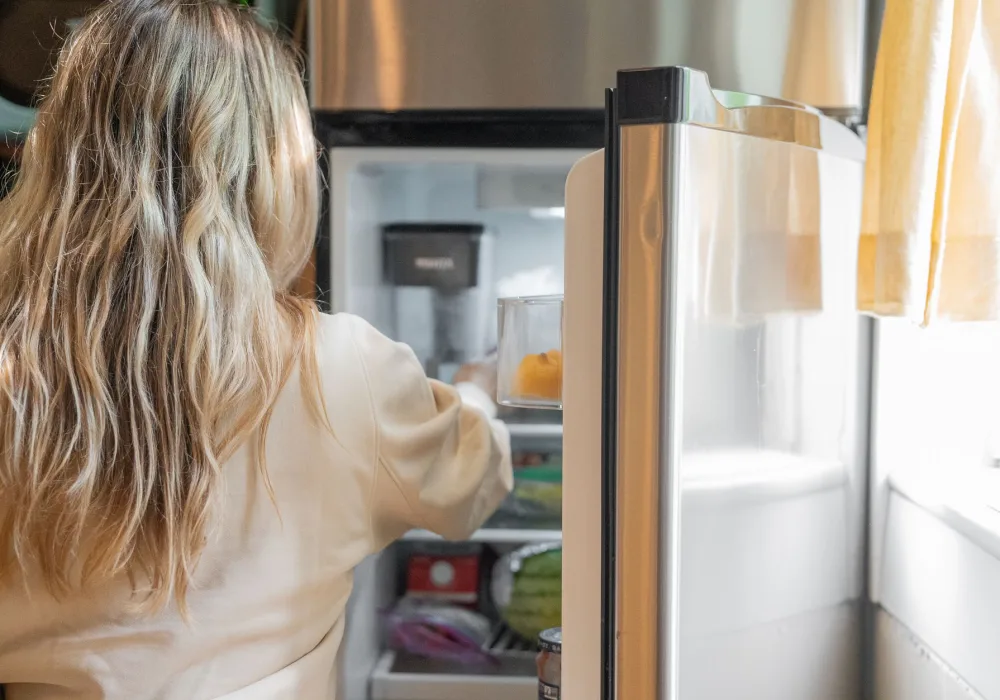 Open refrigerator stocked with fresh food in a family kitchen