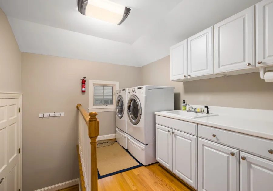 Bright laundry room with a washer and dryer beside a window - Asko dryer repair