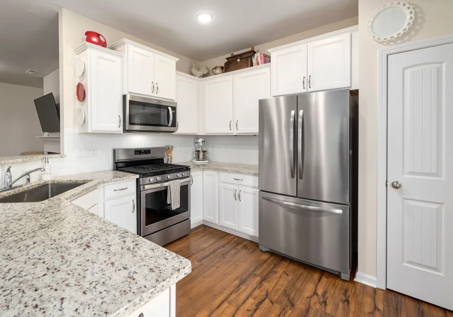 Stainless steel refrigerator in a bright modern kitchen - Bertazzoni refrigerator and freezer repair