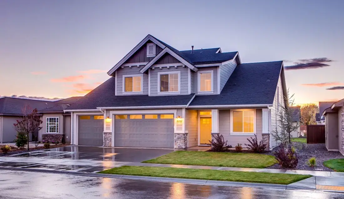 Modern family home with a wide driveway at dusk