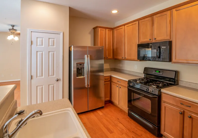 Open refrigerator stocked with fresh food in a bright kitchen