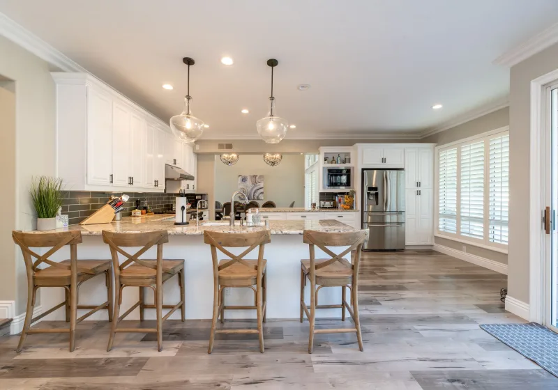 Bright family kitchen with an island and a built-in refrigerator